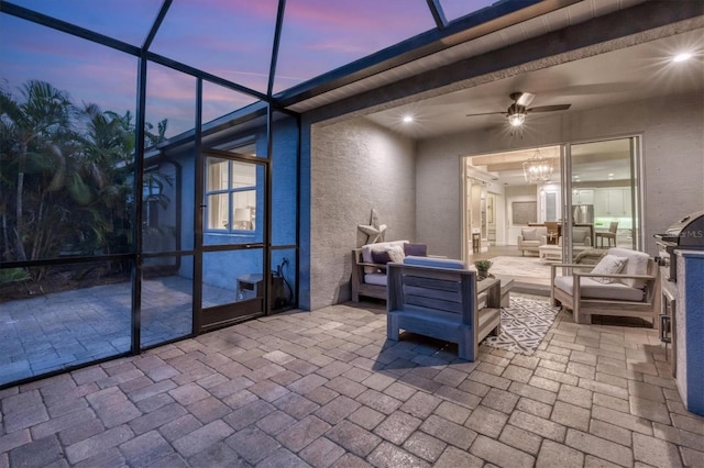 patio terrace at dusk featuring outdoor lounge area and ceiling fan