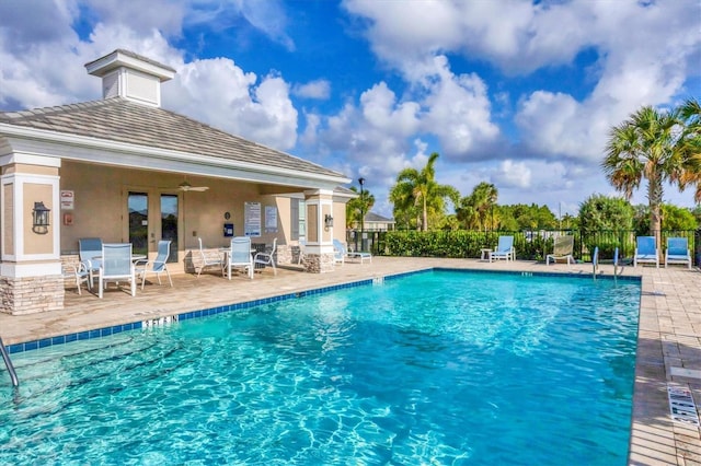 view of pool with a patio and ceiling fan