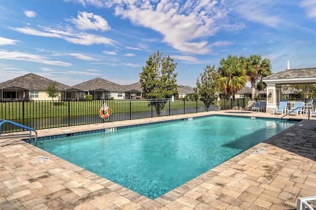 view of swimming pool with a patio and a lawn