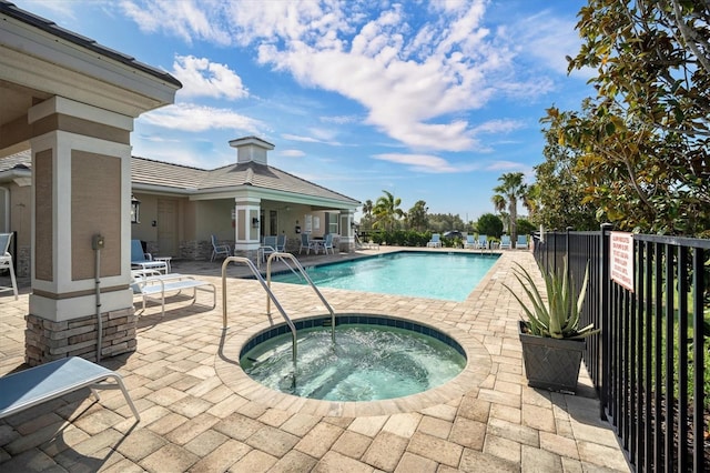 view of pool with a community hot tub and a patio