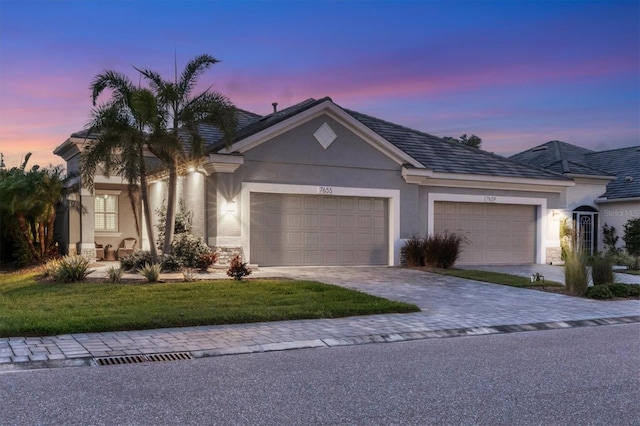 single story home with a yard and a garage