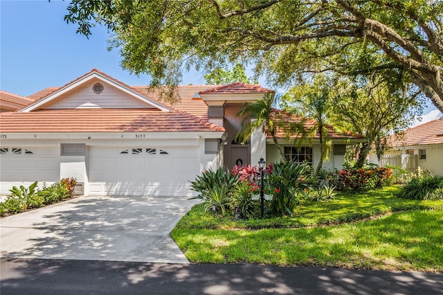 view of front of property featuring a garage and a front lawn