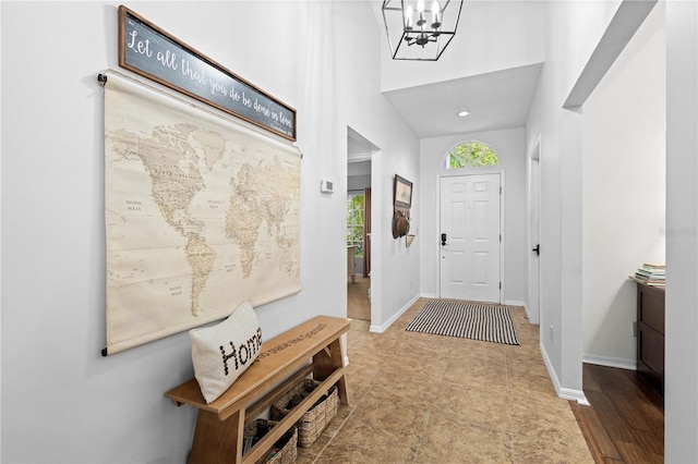 entryway with a notable chandelier and tile floors