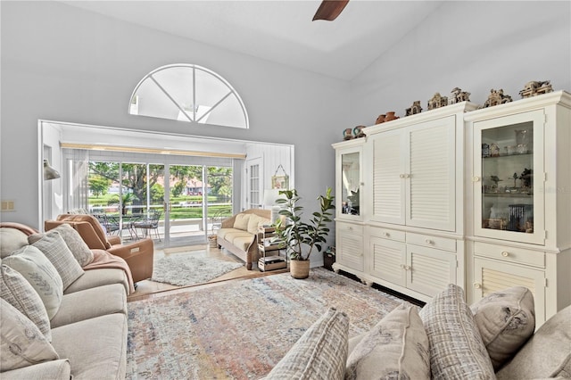 living room with high vaulted ceiling and ceiling fan