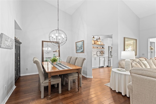 dining room with high vaulted ceiling, an inviting chandelier, and dark hardwood / wood-style floors