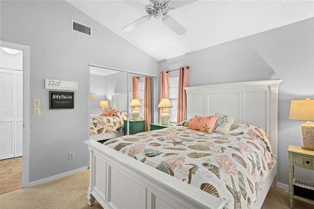 carpeted bedroom with a closet, ceiling fan, and vaulted ceiling