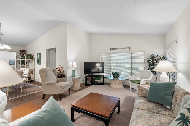 living room with high vaulted ceiling, an inviting chandelier, and wood-type flooring