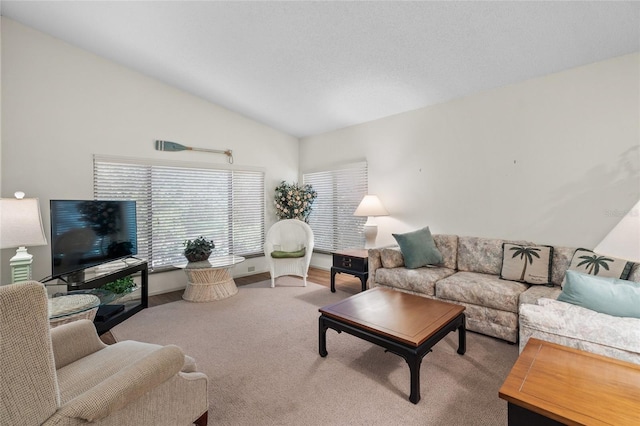 living room with carpet flooring and vaulted ceiling