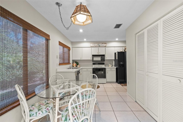 tiled dining area featuring sink