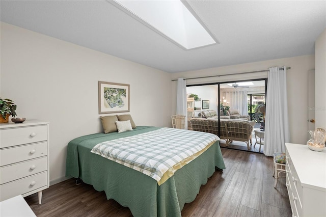 bedroom with a skylight and dark hardwood / wood-style flooring