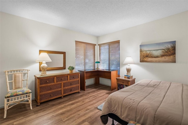 bedroom featuring a textured ceiling and hardwood / wood-style flooring