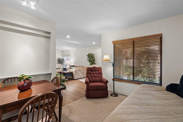 bedroom with hardwood / wood-style flooring and a textured ceiling