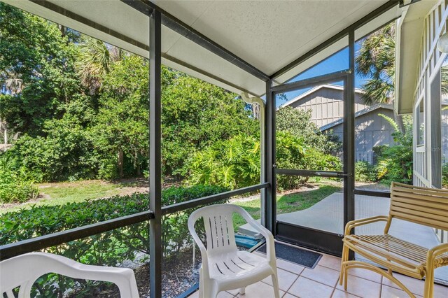 unfurnished sunroom with vaulted ceiling