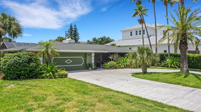 view of front of home with a front lawn and a garage