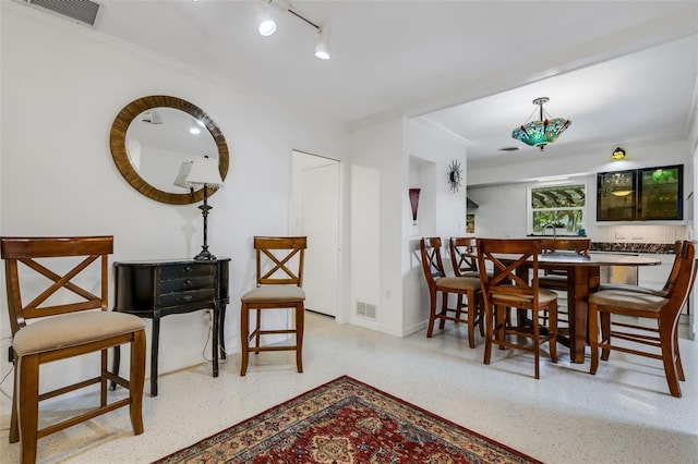 dining space featuring ornamental molding