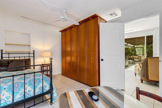 tiled bedroom with ceiling fan