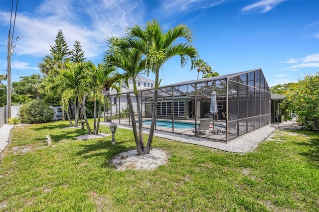 view of pool featuring a lanai, a patio area, and a lawn