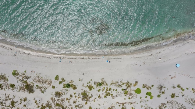 drone / aerial view featuring a water view and a beach view