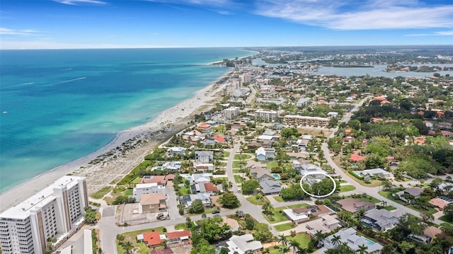 drone / aerial view featuring a view of the beach and a water view