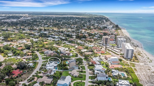 birds eye view of property with a view of the beach and a water view