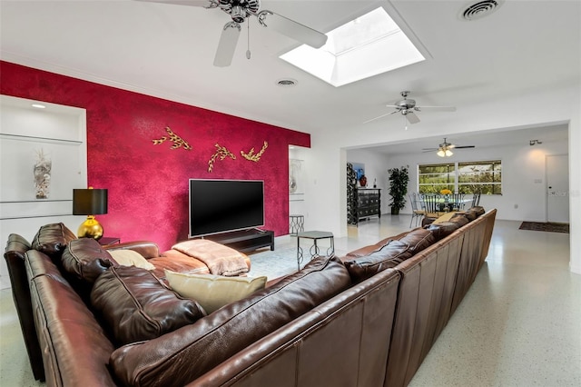 living room featuring a skylight and ceiling fan