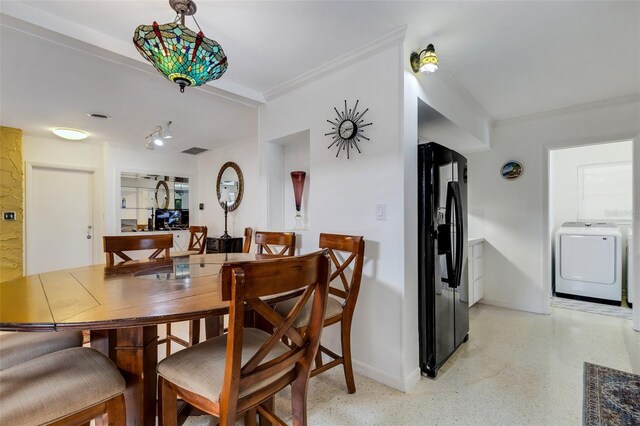 dining area featuring washer / dryer and ornamental molding