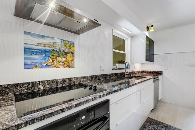 kitchen featuring stainless steel dishwasher, dark stone counters, black electric cooktop, sink, and white cabinets