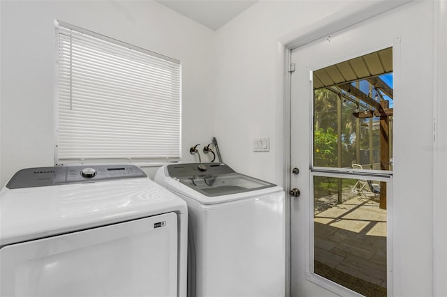 clothes washing area with washing machine and dryer and plenty of natural light