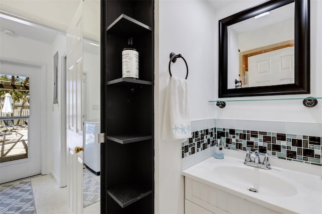 bathroom with tasteful backsplash, washer / clothes dryer, and vanity