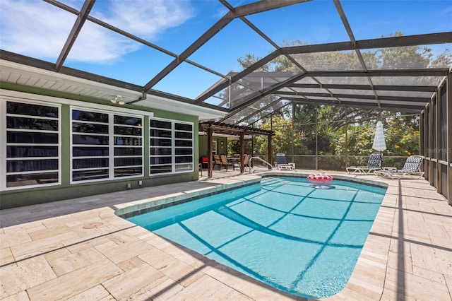 view of swimming pool with glass enclosure and a patio area