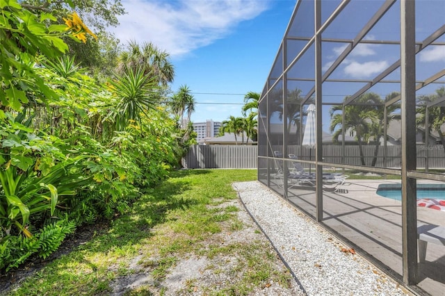 view of yard with a lanai, a fenced in pool, and a patio