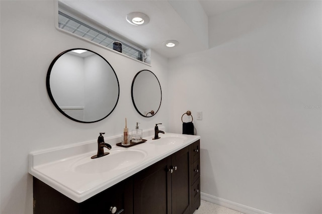 701 Armada Rd S, Venice, FL 34285 - bathroom featuring baseboards, a sink, and double vanity