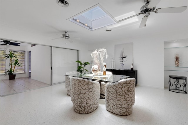 701 Armada Rd S, Venice, FL 34285 - dining space with speckled floor, a ceiling fan, visible vents, and a skylight