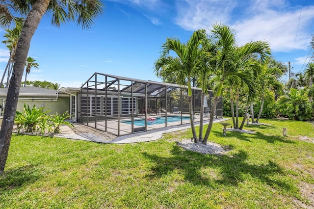 701 Armada Rd S, Venice, FL 34285 - outdoor pool featuring glass enclosure, a yard, and a patio