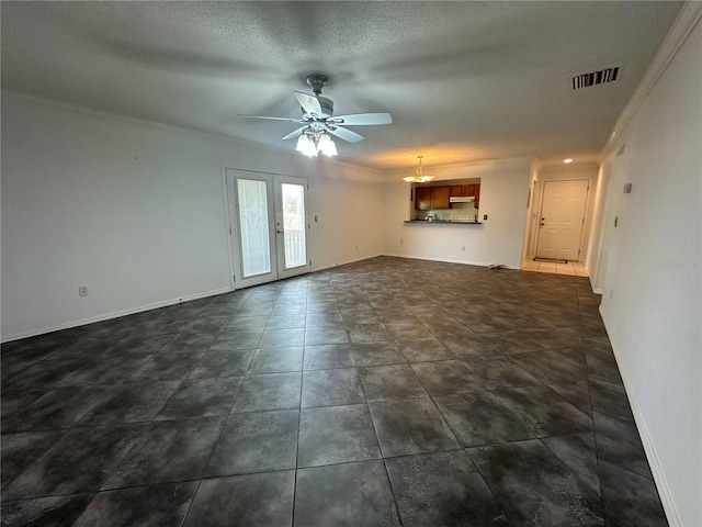 unfurnished living room with french doors, ornamental molding, a textured ceiling, ceiling fan, and dark tile floors