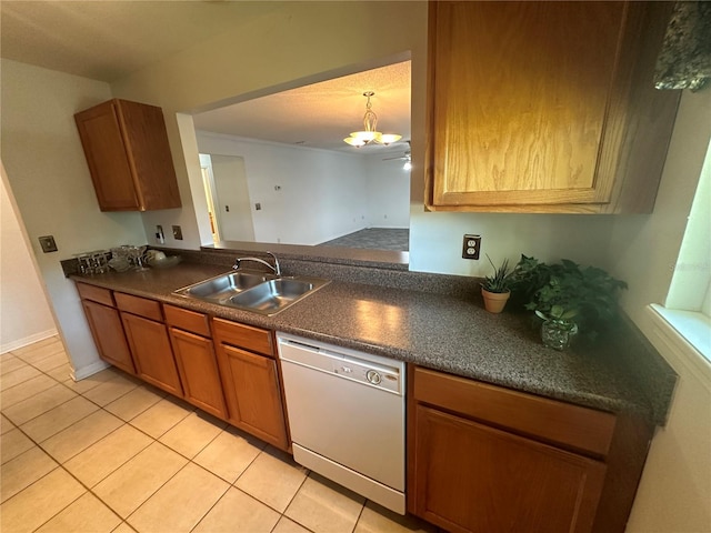 kitchen with decorative light fixtures, light tile floors, sink, and white dishwasher