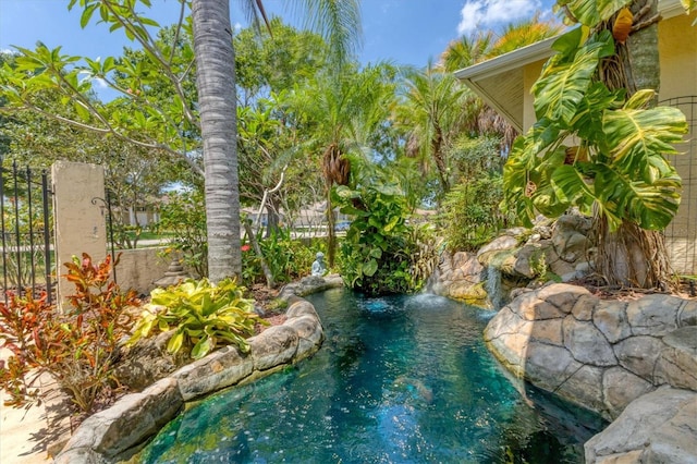 view of swimming pool with pool water feature