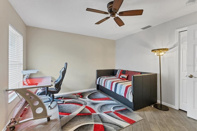 bedroom with ceiling fan and light hardwood / wood-style floors