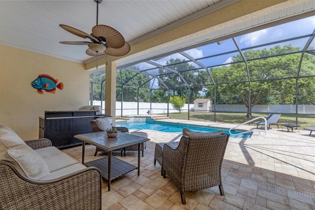 view of patio / terrace with an outdoor living space, ceiling fan, a lanai, and a fenced in pool