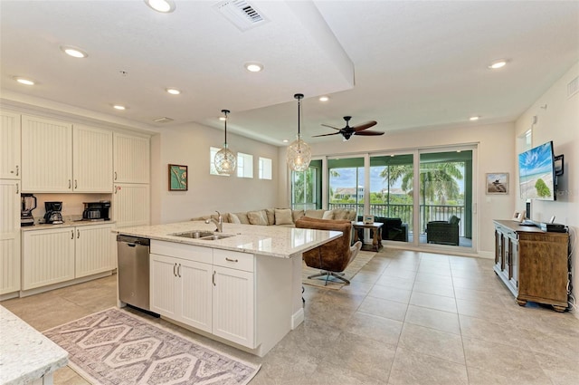 kitchen with light tile flooring, dishwasher, a center island with sink, ceiling fan, and sink