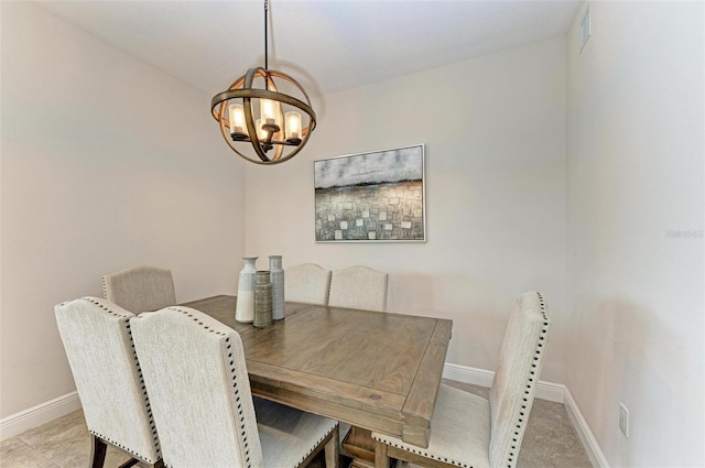 dining room featuring tile floors and an inviting chandelier