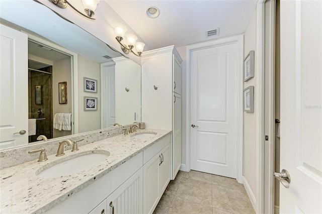 bathroom with tile floors, an enclosed shower, vanity with extensive cabinet space, and dual sinks