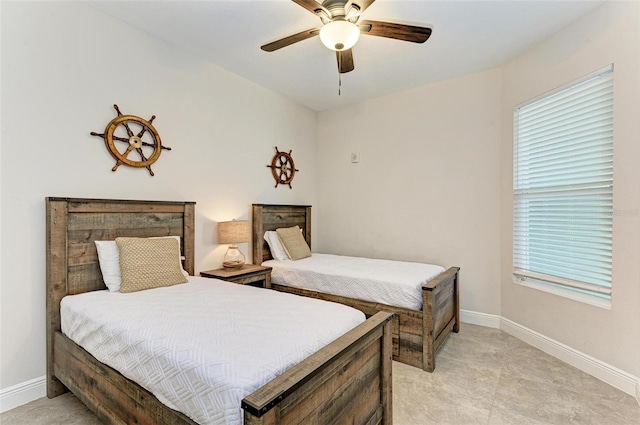 bedroom featuring ceiling fan and light tile floors