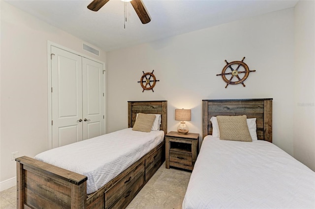 bedroom with a closet, ceiling fan, and light tile floors