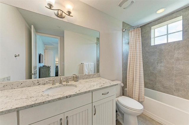 full bathroom featuring toilet, large vanity, and shower / bath combo