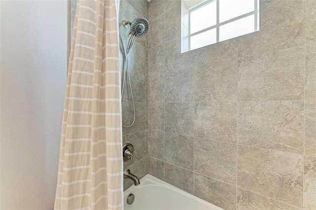 bathroom with shower / tub combo with curtain