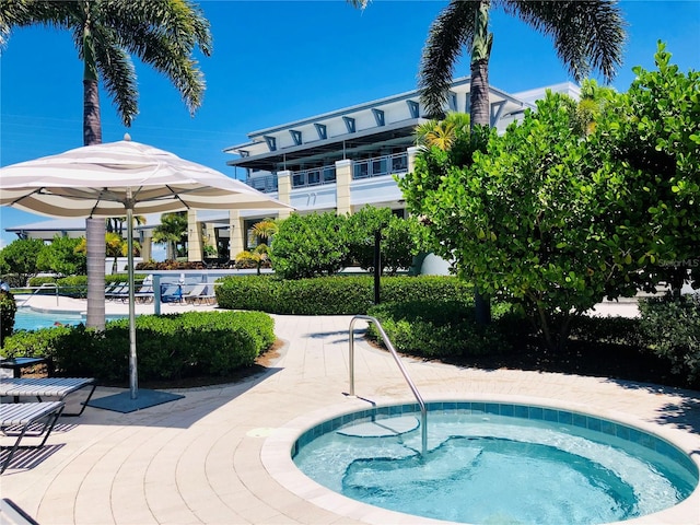 view of swimming pool with a hot tub