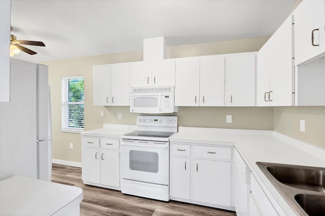 kitchen featuring white appliances, white cabinets, sink, light hardwood / wood-style flooring, and ceiling fan