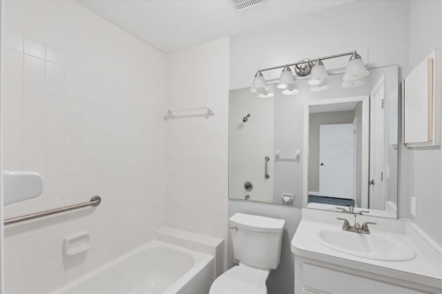 full bathroom with tiled shower / bath, vanity, and toilet