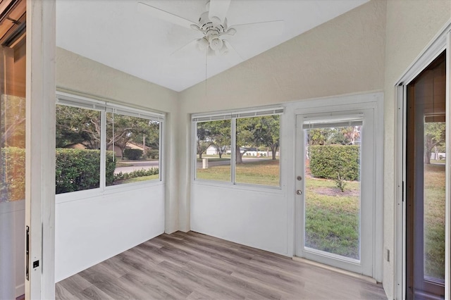 unfurnished sunroom with ceiling fan and lofted ceiling